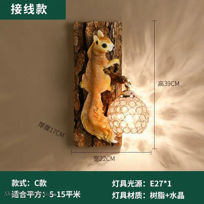 A nordic vintage style resin squirrel wall lamp in golden brown mounted on a textured tree trunk base with crystal globe lamp