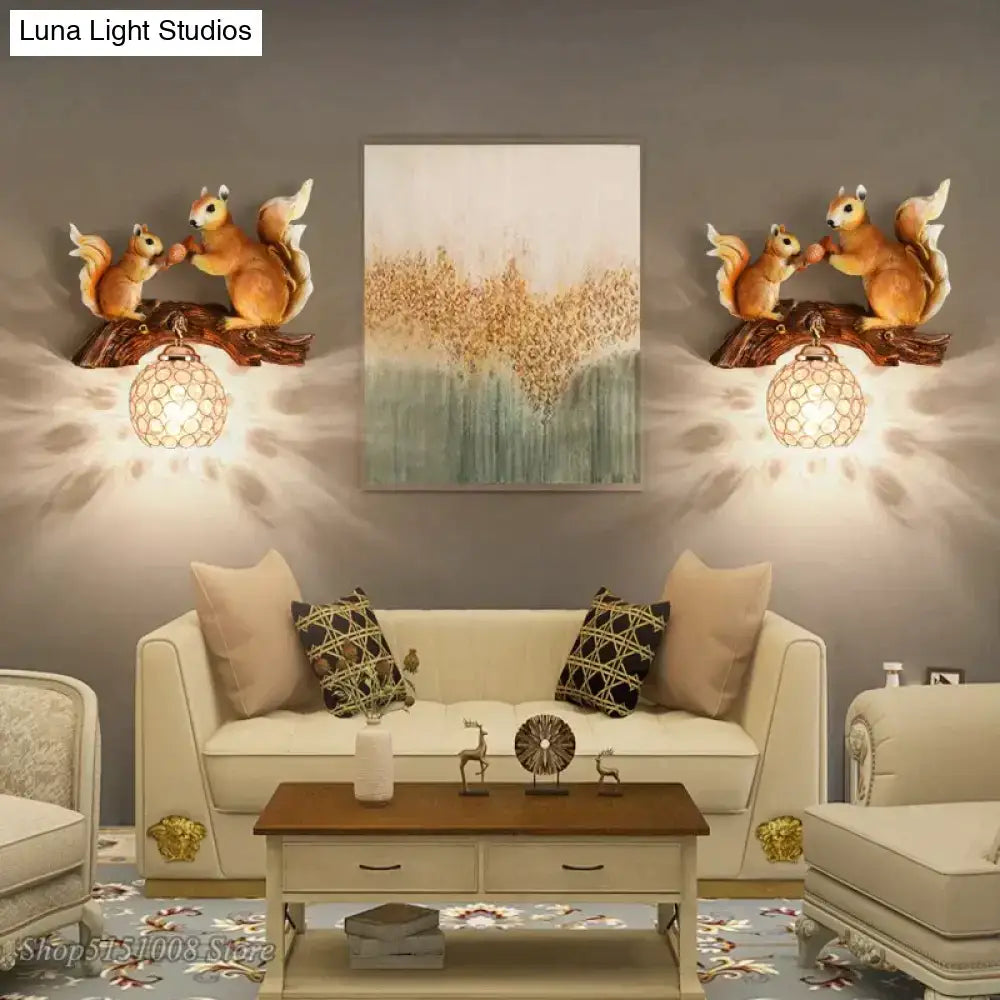 Pair of bronze-colored vintage style resin squirrel wall lamps with detailed fur mounted on dark wood branches above sofa