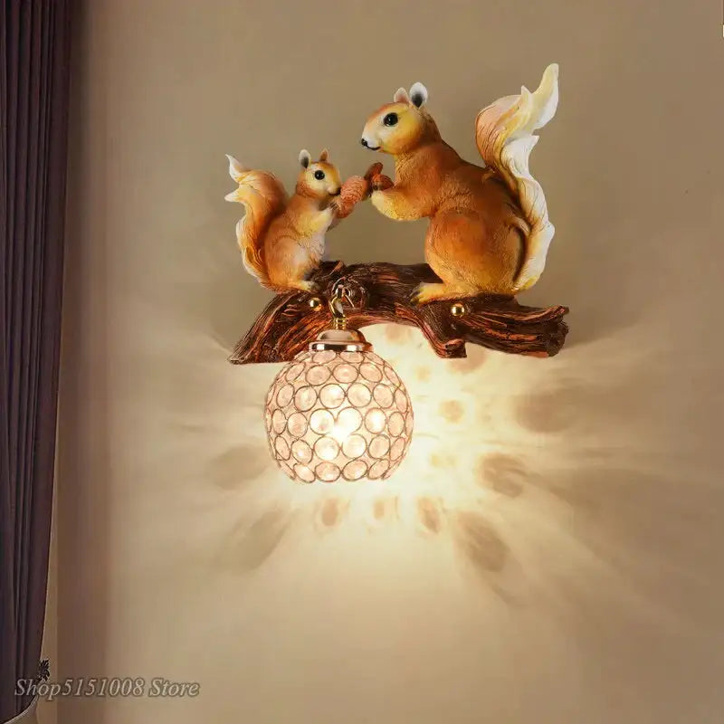Nordic vintage style resin wall lamp featuring two detailed warm-toned squirrels on a branch above a crystal globe shade