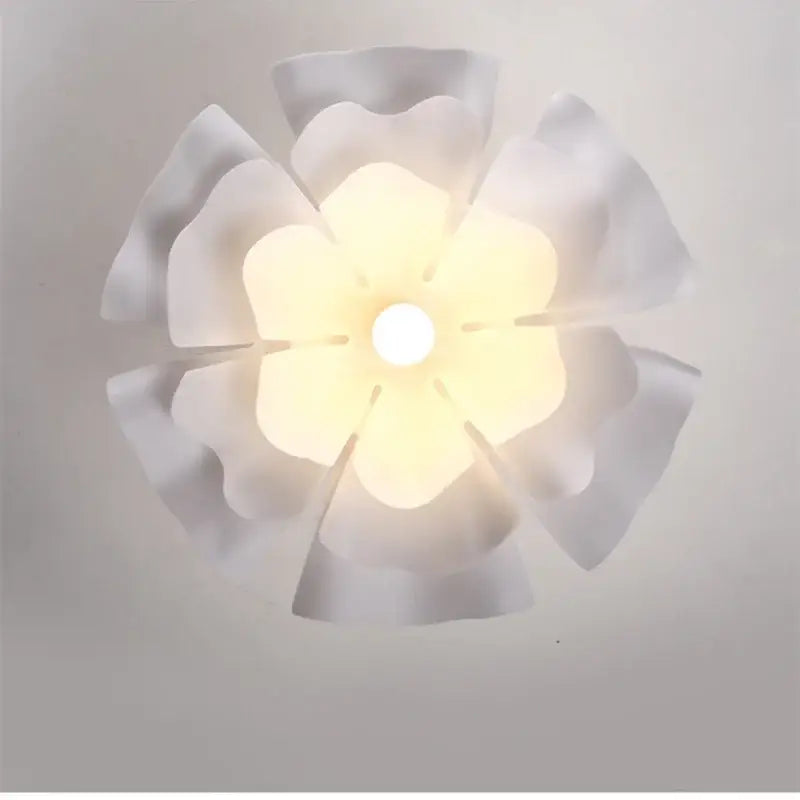Nordic white acrylic flower pendant chandelier with a soft glowing petal-shaped ceiling light fixture for bedroom decor