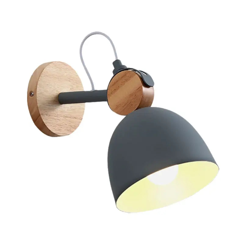 Nordic white and wood wall lamp with angle adjustable domed shade, matte black metal shade, and natural wood accents