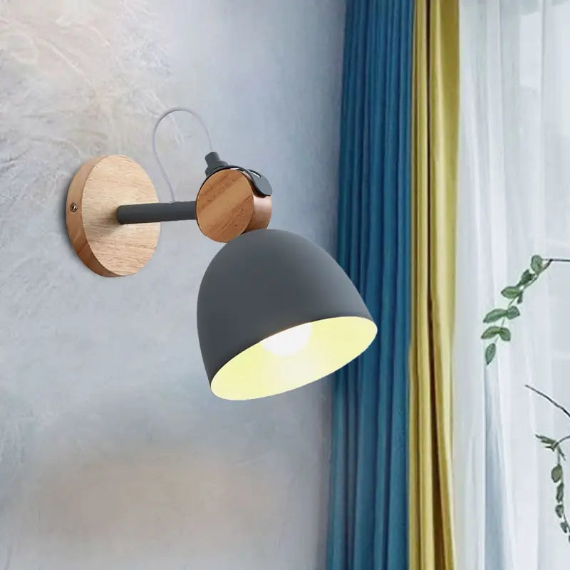 Modern nordic wall lamp with angle adjustable matte gray domed shade, wooden base, and black metal joints for bedroom