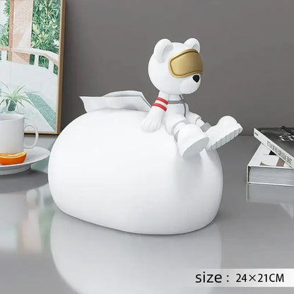 White astronaut-themed tissue box holder with glossy finish and gold visor paired with nordic bear statues tissue decor
