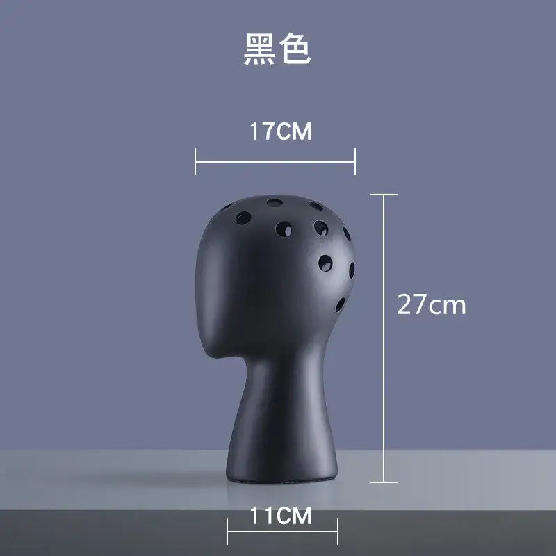 Black ceramic human head vase with multiple circular holes designed for living room decorbites human head decor