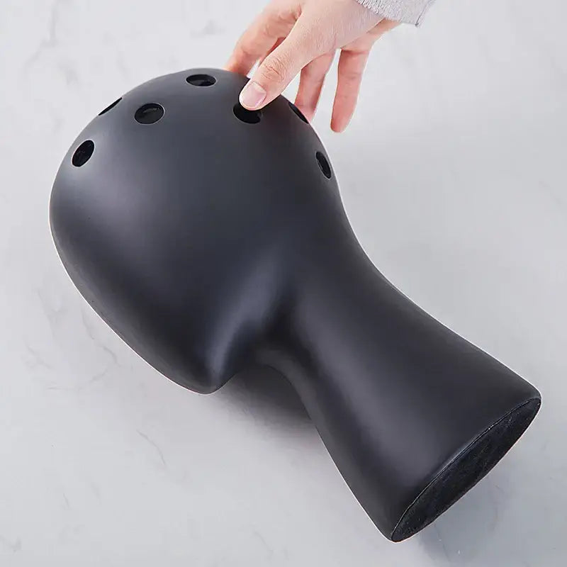 Black ceramic ocarina with multiple circular finger holes and matte finish decorbites human head ceramic vase decor
