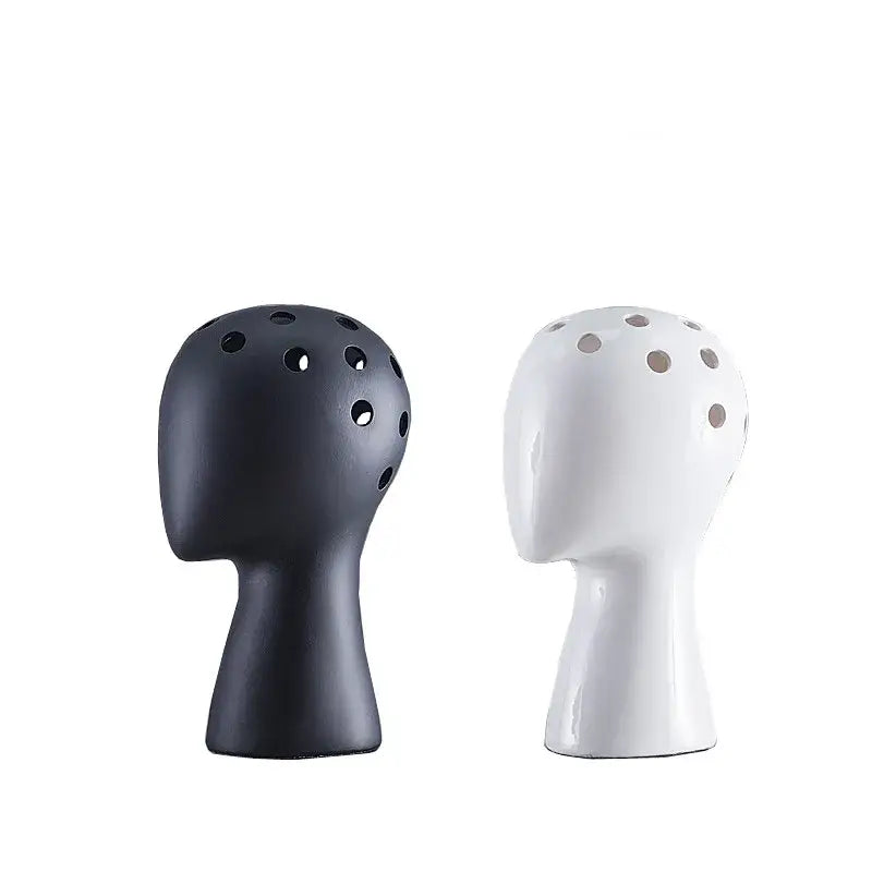 Nordic white human head ceramic vase with sleek black and white glossy finish and circular perforations for decorbites human head decor
