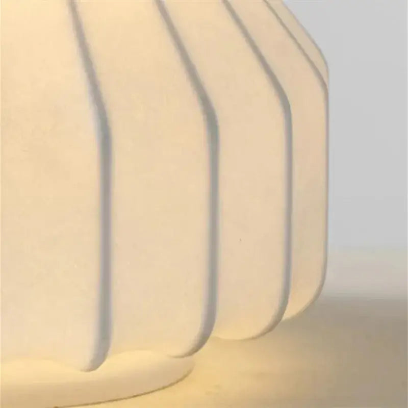 Cream-colored ribbed ceramic table lamp base with a matte finish for bedroom decorbites gatto silk lighting