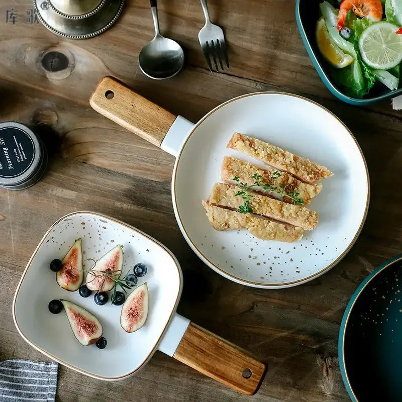 Nordic white speckled ceramic wood handle skillet with gold rim featuring decorbites ceramic wood handle detail