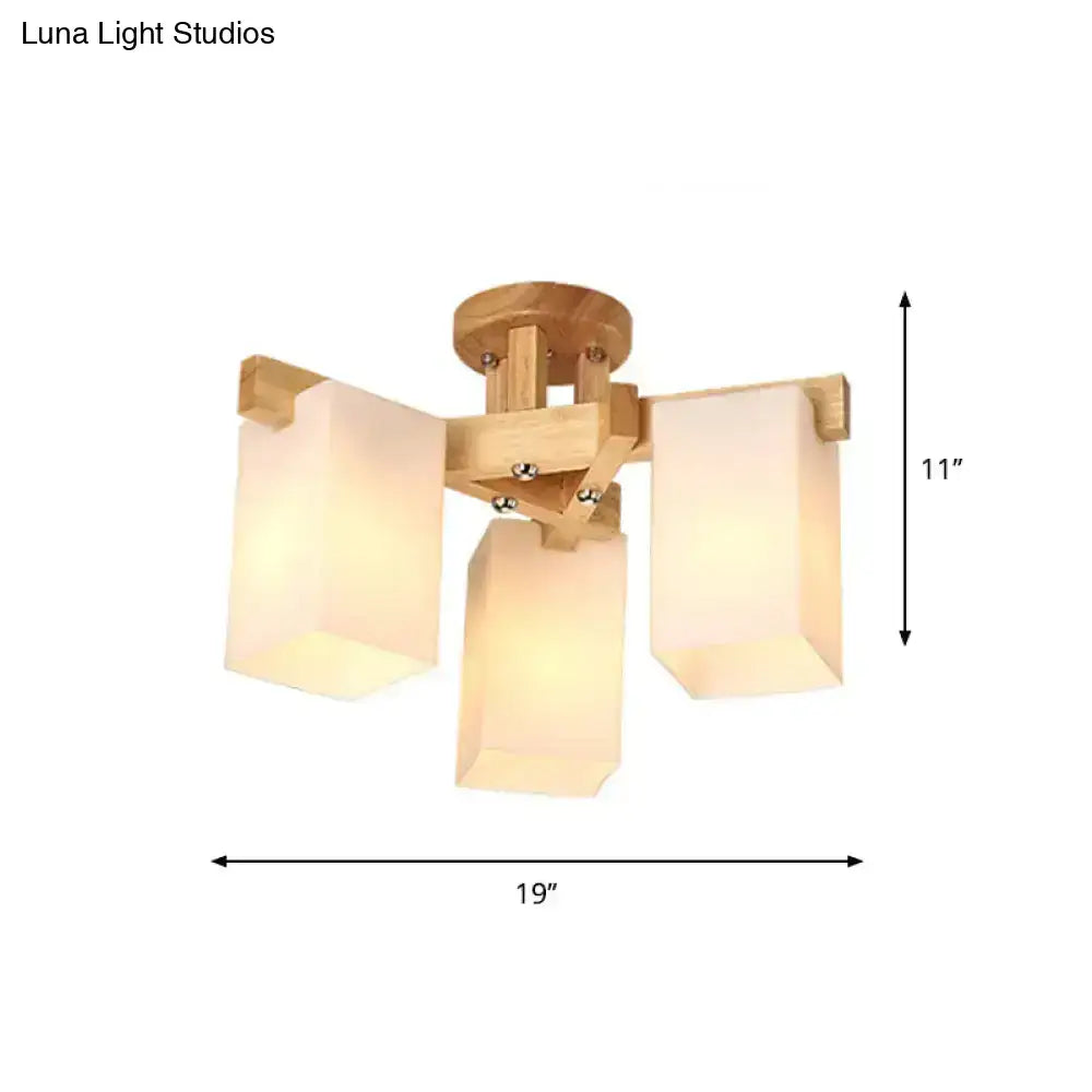 Lightweight wooden ceiling lamp with three cuboid cream glass shades for living room lighting