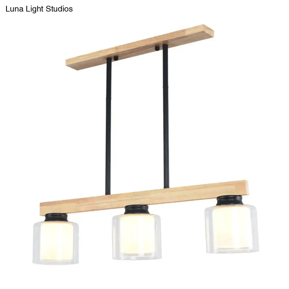 Modern farmhouse pendant light with natural wood frame black metal rods and three clear glass shades for island lighting
