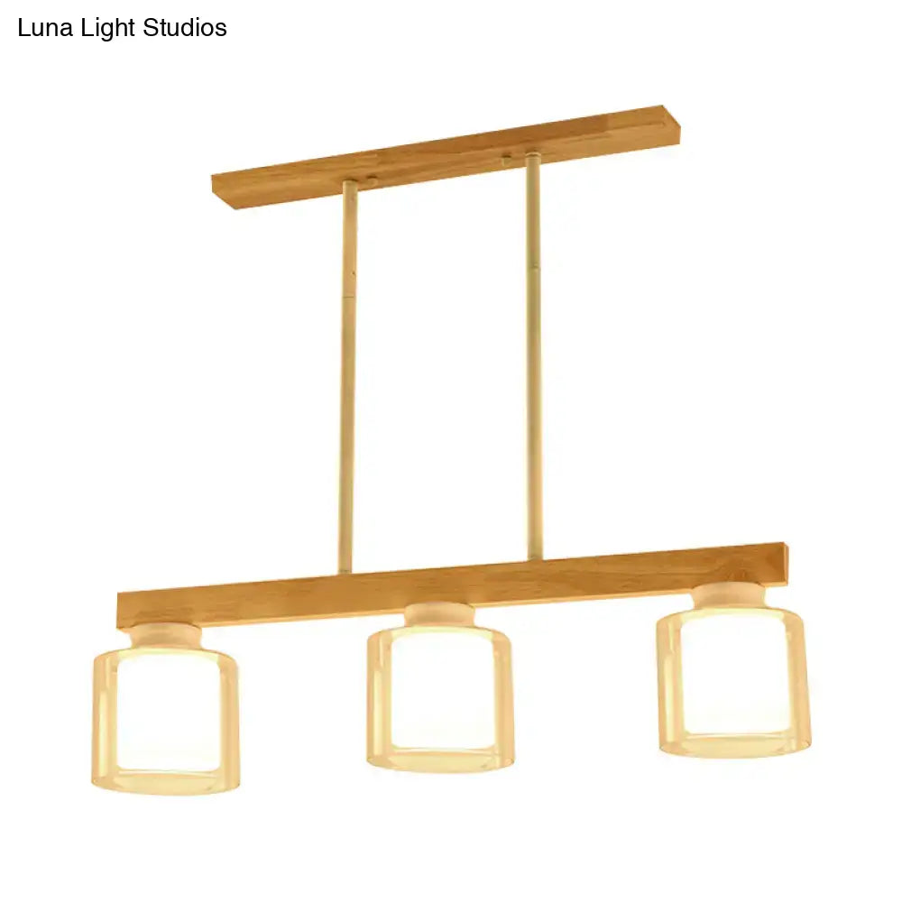 DecorBites Nordic wooden linear pendant light with three white glass shades and brass accents for restaurant island lighting