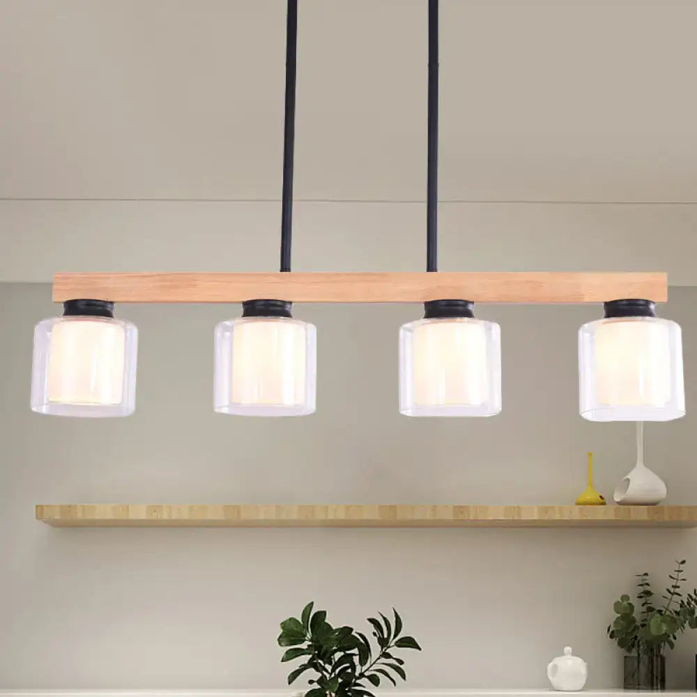 Modern minimalist pendant light with natural wood bar black metal accents and double clear glass cylinder shades for island lighting