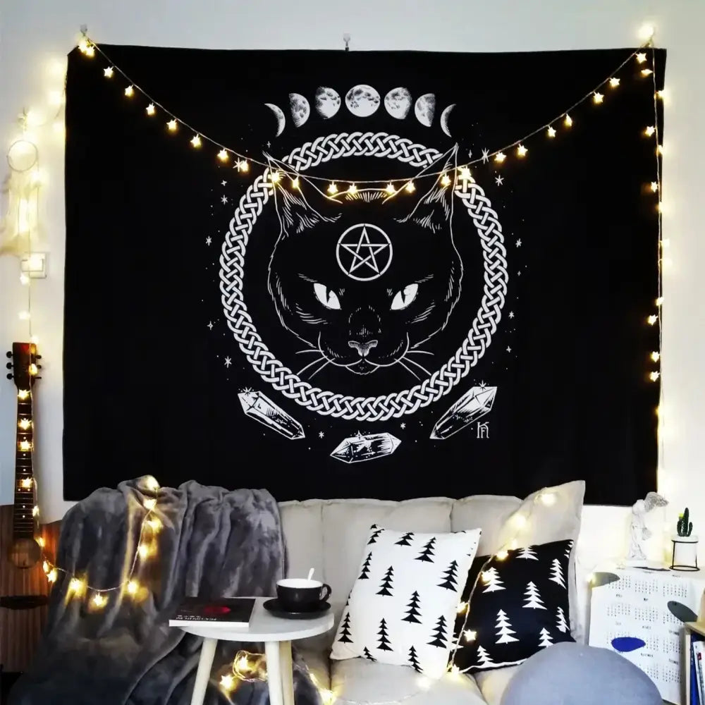 Black tapestry featuring white line-art cat coven face with pentagram, celtic knot and moon phases for mysterious decor