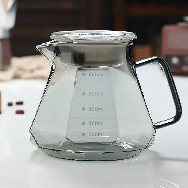 Octagonal decorbites glass coffee kettle with clear faceted glass, black metal handle, lid, and volume markings from 200ml to 600ml