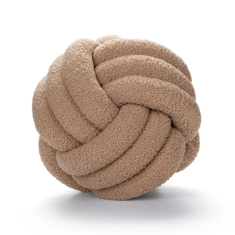 Off-white boucle knotted circle throw pillow in beige with a plush textured surface for bedroom decor