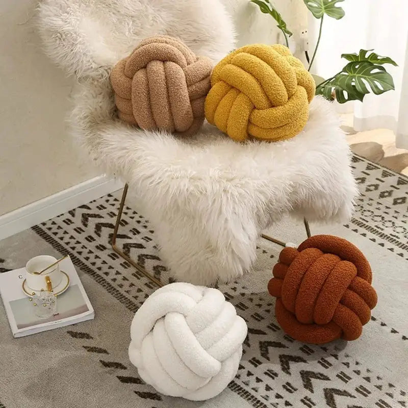 Soft plush boucle knotted circle throw pillows in beige yellow white and rust tones for bedroom decorbites decor