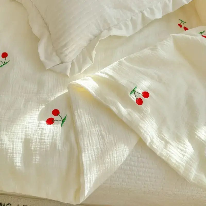 Off-white cotton summer quilt with delicate red cherry embroidery featuring double layer yarn design