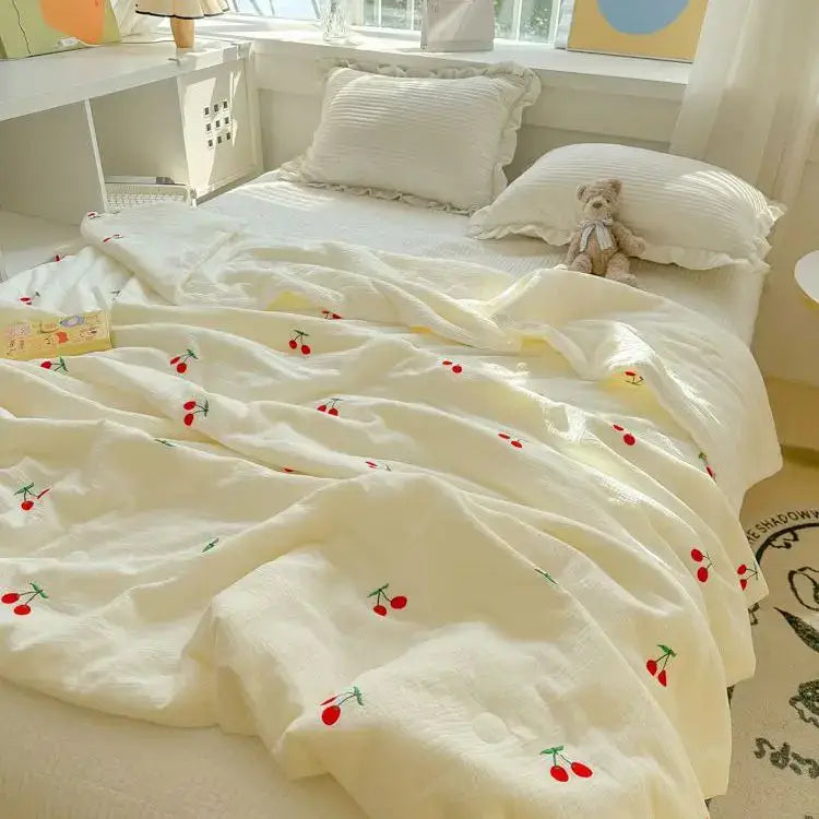 Off-white cream-colored double layer yarn summer quilt with quilted texture and embroidered red cherries and green stems