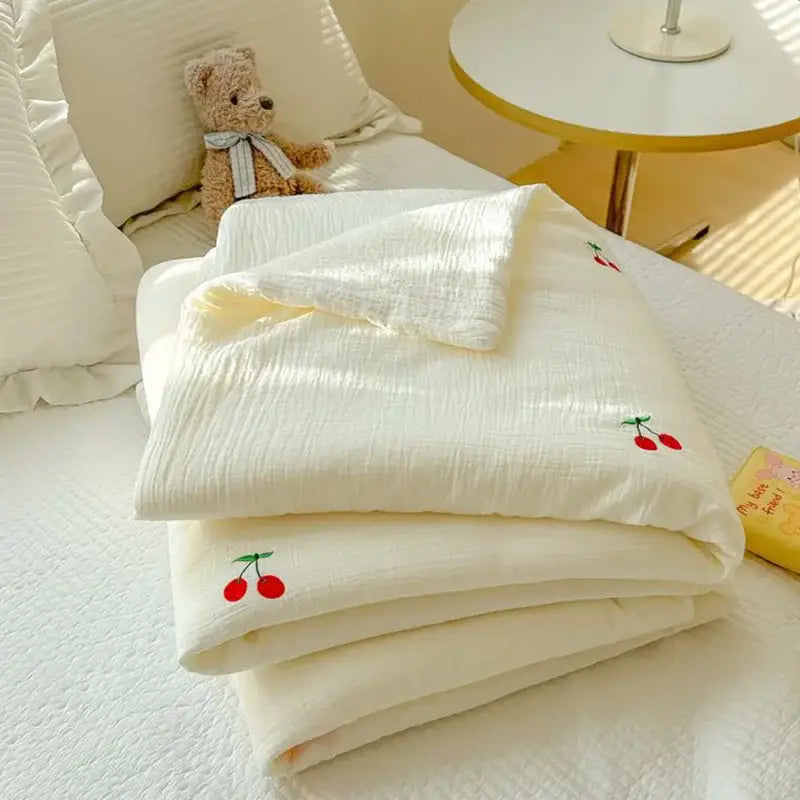 Off-white cotton muslin summer quilt with double layer yarn and embroidered red cherry motifs for bedroom use