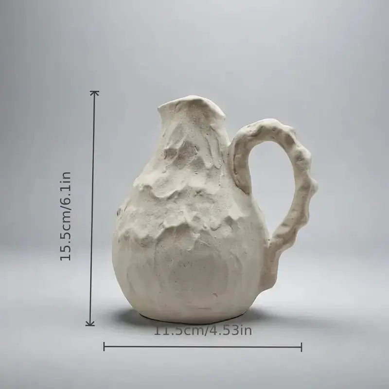 Off-white handmade irregular grain ceramic pitcher with textured surface and irregular handle for living room decorbites decor