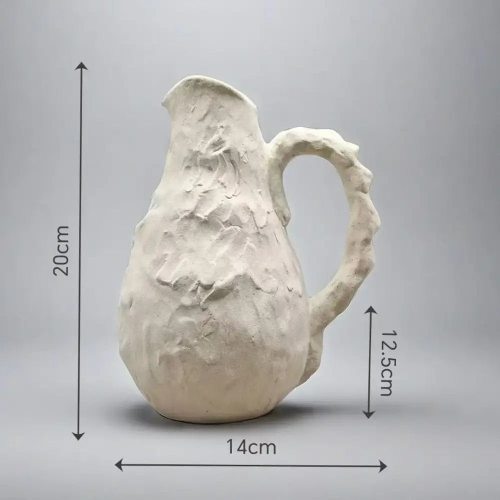 Off-white handmade irregular grain ceramic pitcher vase with a textured rustic handle ideal for living room decorbites decor
