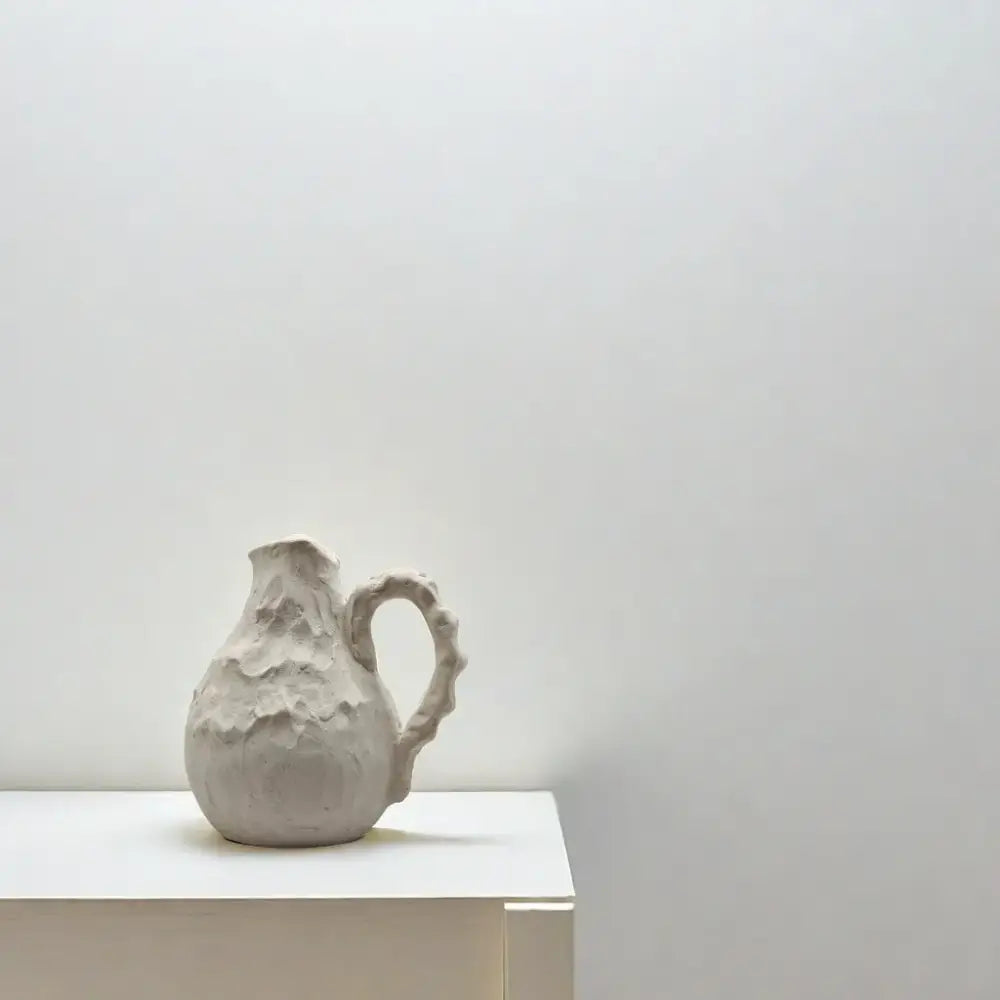 Off-white handmade irregular grain ceramic pitcher vase with textured finish and organic handle for living room decorbites handmade irregular