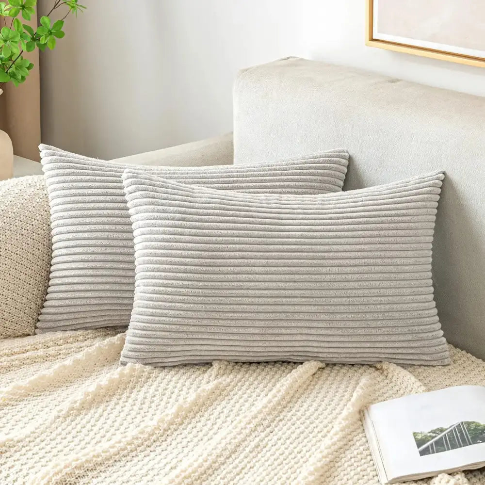 Two off white ribbed corduroy striped throw pillow covers on a cozy knit blanket decorbites corduroy striped pillow covers