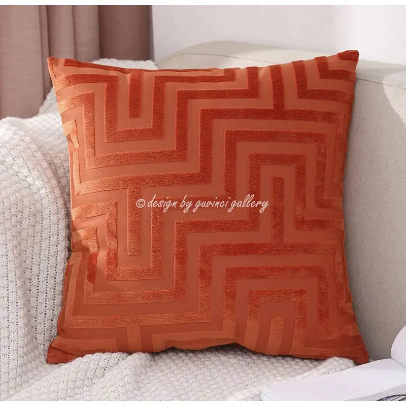 A square rust-orange velvet decorbites geometric jacquard throw pillowcase with raised zigzag pattern for living room