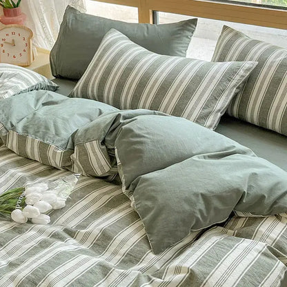 Olive and cream cotton striped bedding set featuring muted green and white linen with a soft textured finish