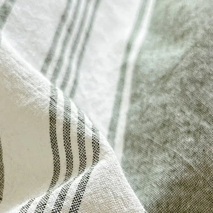 Olive and cream cotton striped bedding set showing a soft textured linen fabric with thin black and white stripes