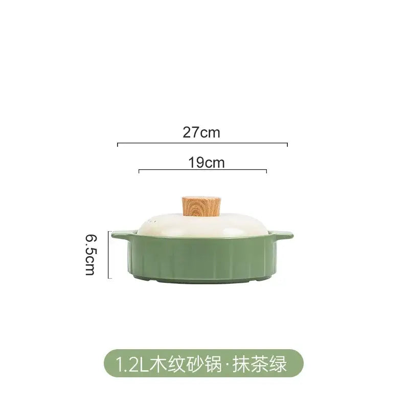 A 1.2l matte sage green ceramic casserole pot with ribbed texture and cream lid with wood handle for gas stove rice
