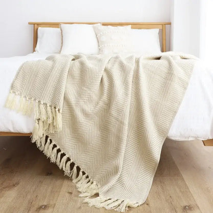 Cream-colored woven throw blanket with herringbone pattern and tassels for decorbites geometric knitted blanket decor