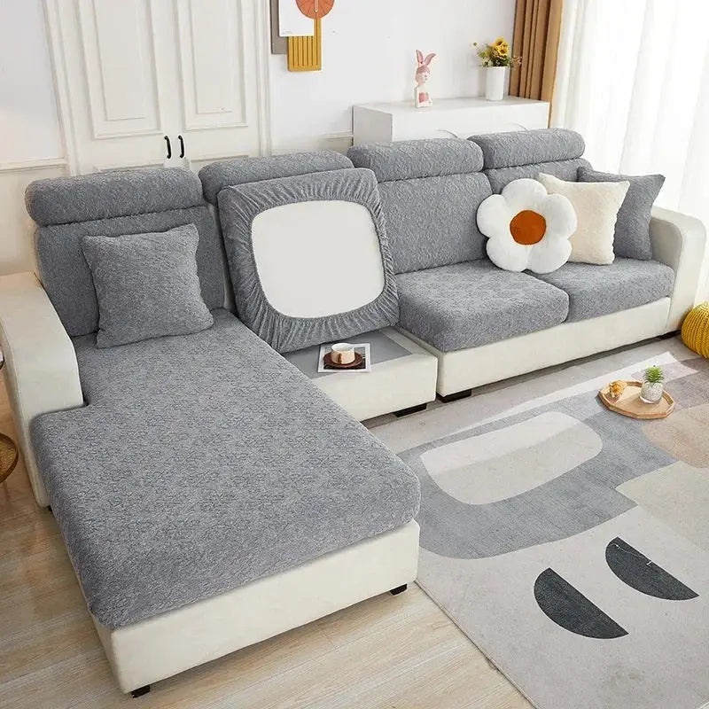 Gray textured fabric sofa seat cover with elasticized edges and white square cutout on backrest for living room protection