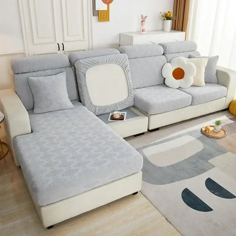Light gray textured fabric sofa seat cover with subtle pattern and elasticized edges for living room protection