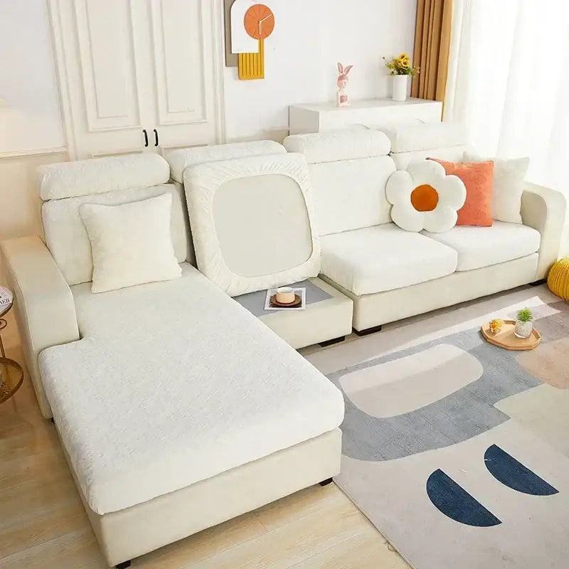 Cream-colored plush sofa seat cover with soft textured fabric draped over sectional cushions and backrest for living room protector