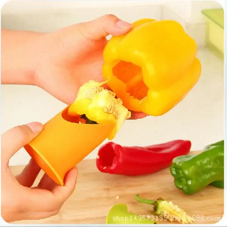 Orange plastic vegetable cutter corer seed remover removing seeds from a yellow bell pepper in kitchen use