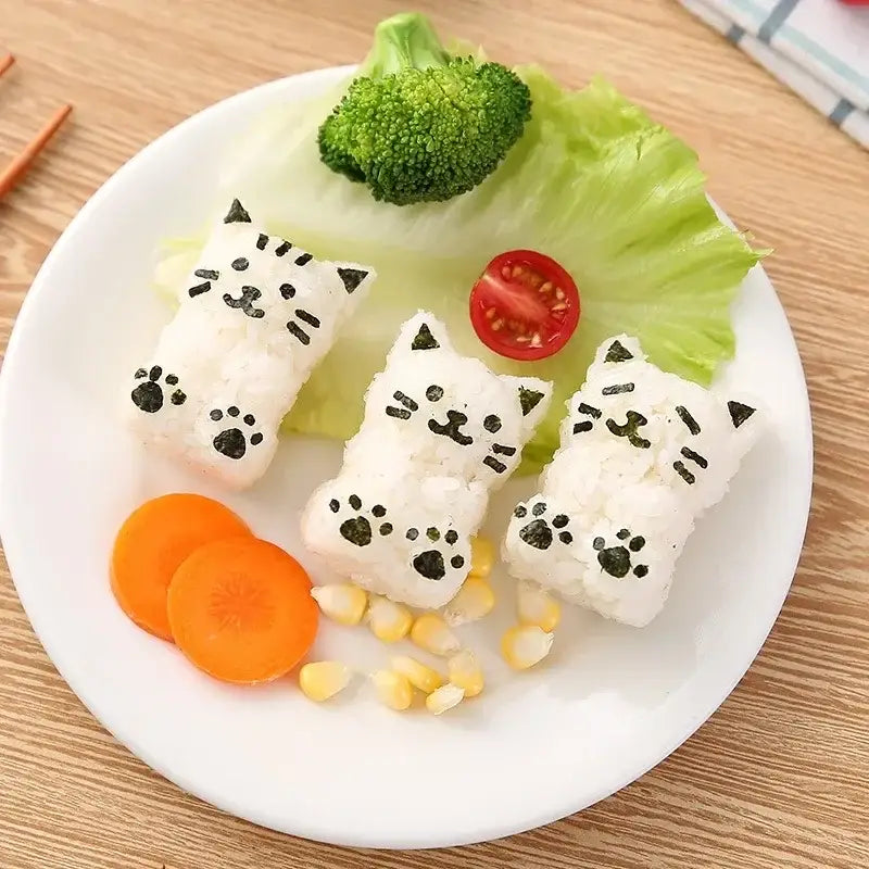 Three white rice cat shape onigiri made with orange and white decorbites cat shape onigiri maker kitchen mold kit