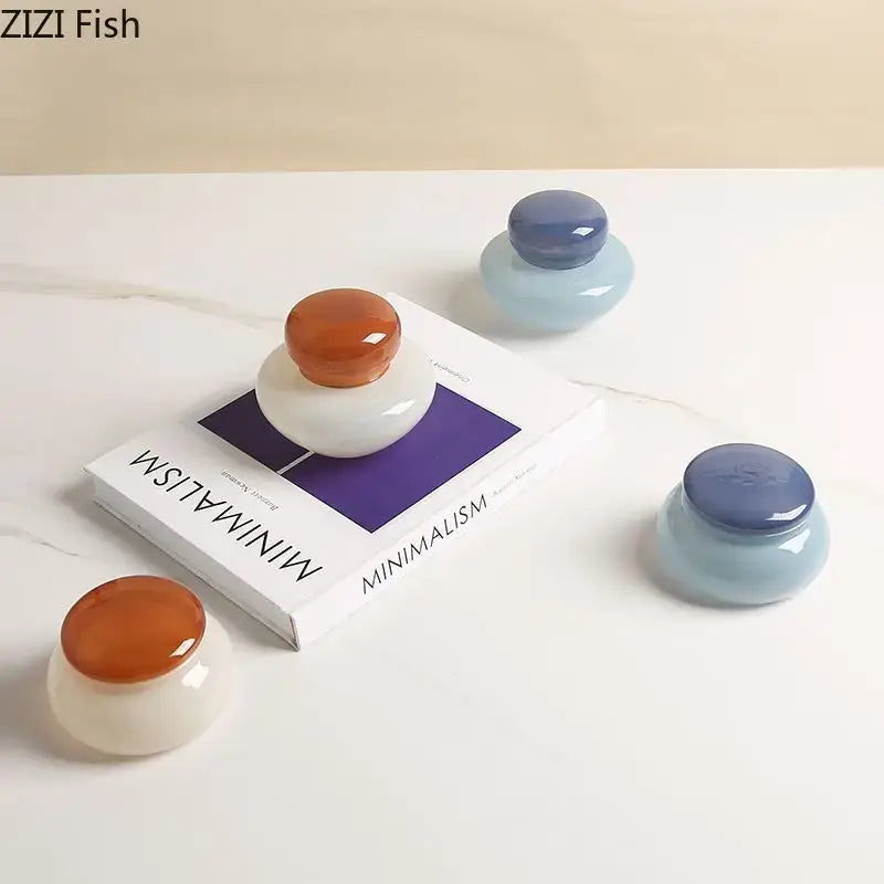 Minimalist ceramic glass storage jar set with glossy orange and blue lids for kitchen candy storage