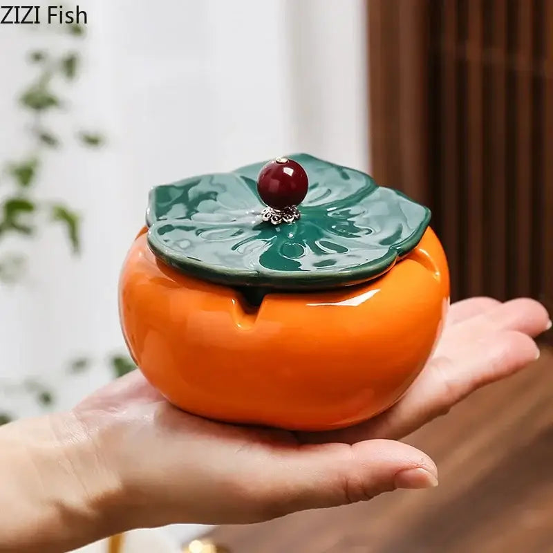Orange ceramic persimmon-shaped ashtray with green leaf lid and red bead centerpiece decorbites ceramic ashtray