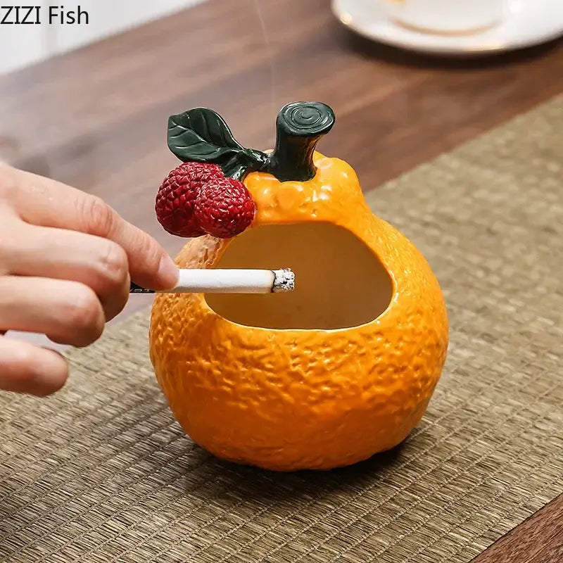 Orange ceramic fruit ashtray with textured peel and green accents for living room decorbites ceramic ashtray