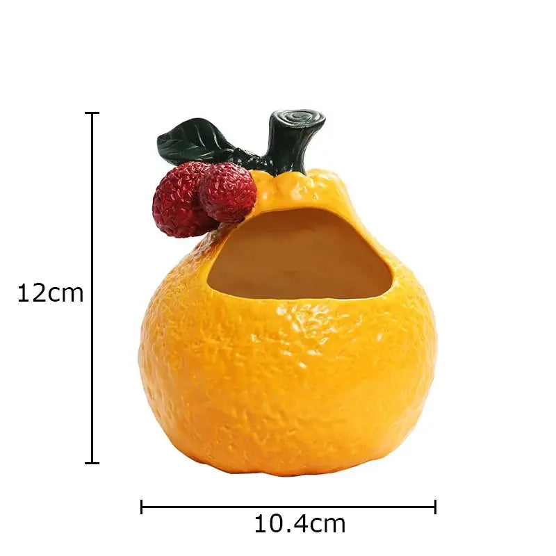 Vibrant orange citrus-themed decorbites ceramic ashtray with textured peel and black stem accented by two red berries
