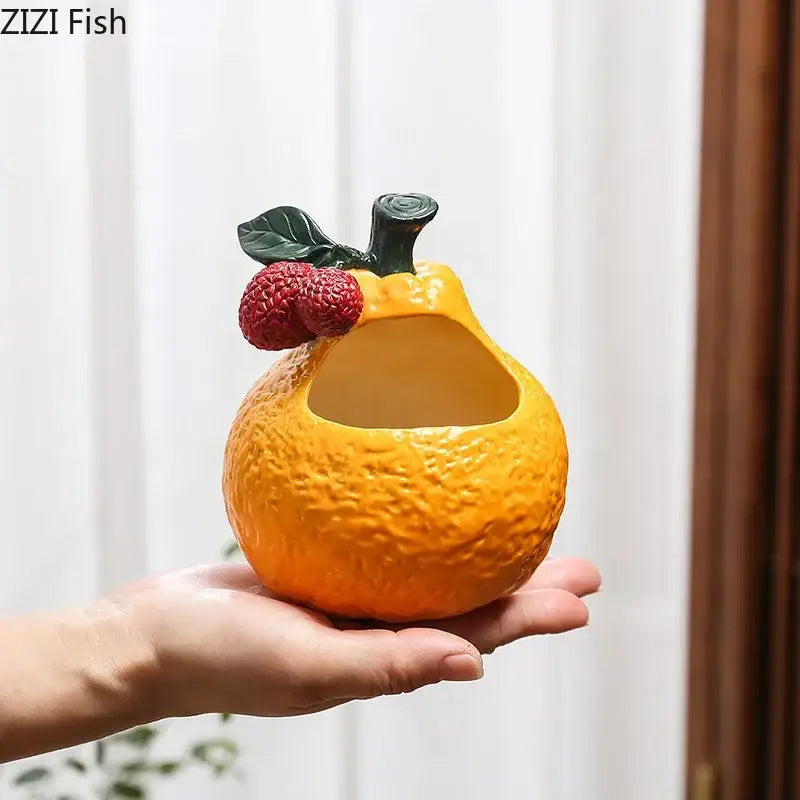 Vibrant orange ceramic ashtray shaped like fruit with textured peel and green stem from decorbites ceramic ashtray collection