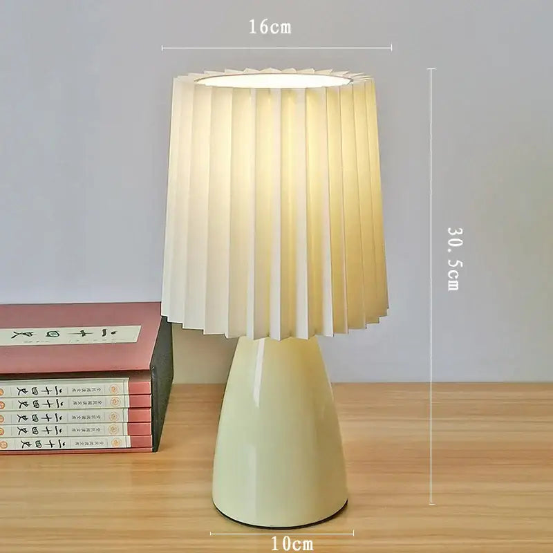 Cream-colored decorbites ceramic milkshake bedside lamp with pleated softly glowing shade for bedroom decor