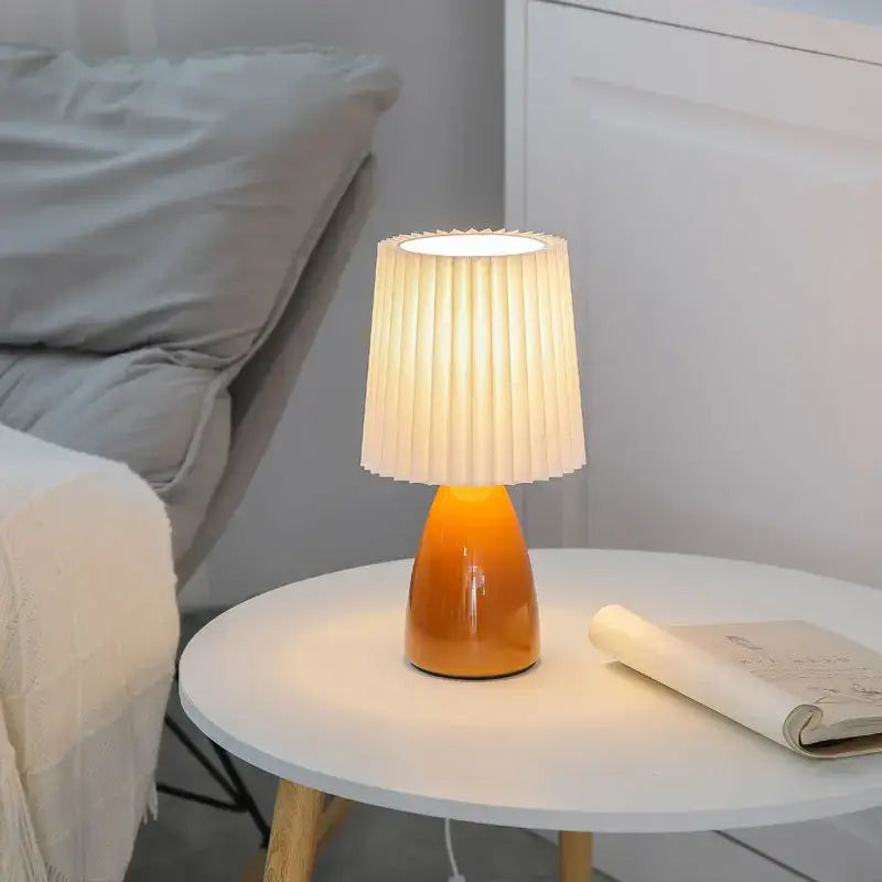 Warm orange ceramic milkshake bedside lamp with pleated off-white fabric shade for bedroom decorbites ceramic milkshake