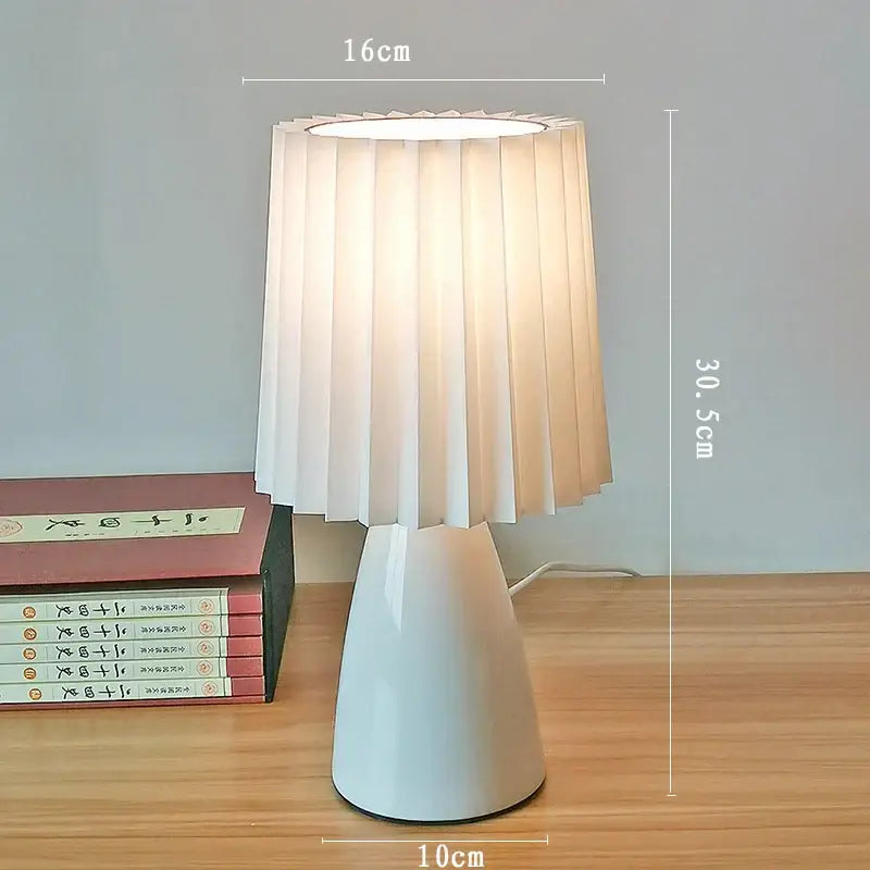 A modern orange ceramic milkshake bedside lamp with a white pleated shade for bedroom decorbites ceramic milkshake