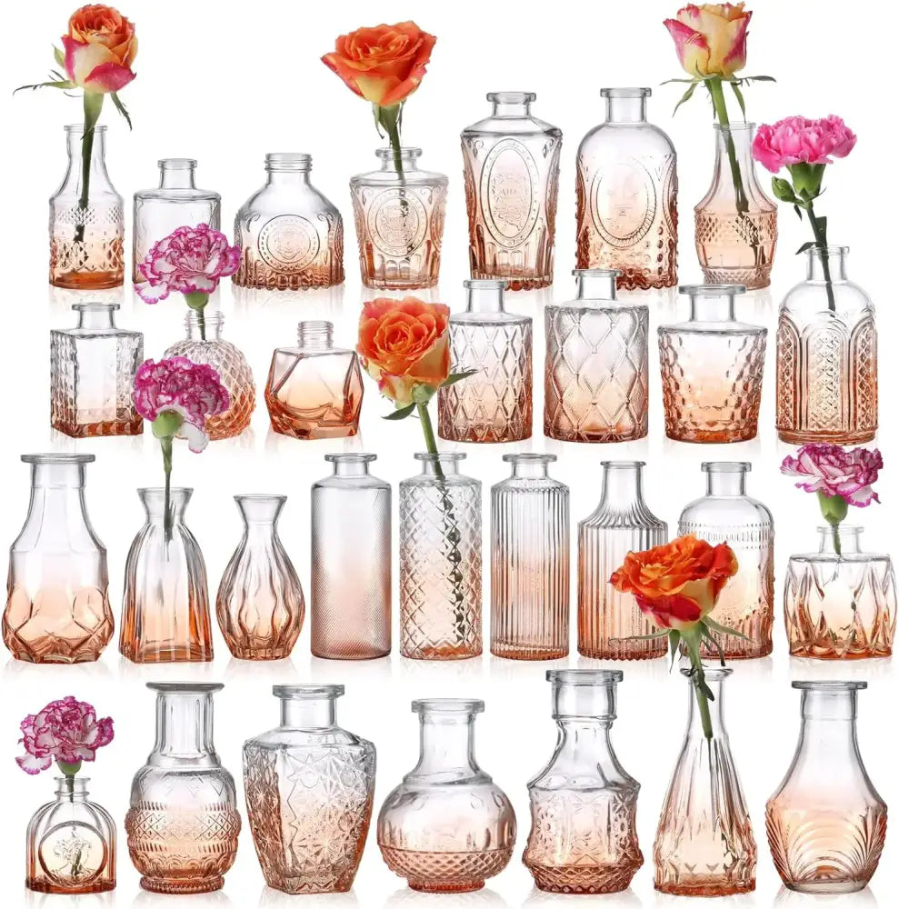 A collection of orange glass bud vases with rose-gold gradient finishes and embossed patterns for wedding centerpieces