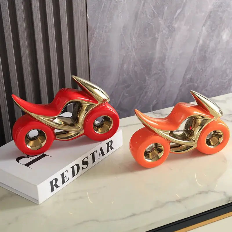 Two glossy ceramic motorcycle light decorations in red gold and orange gold for living room display