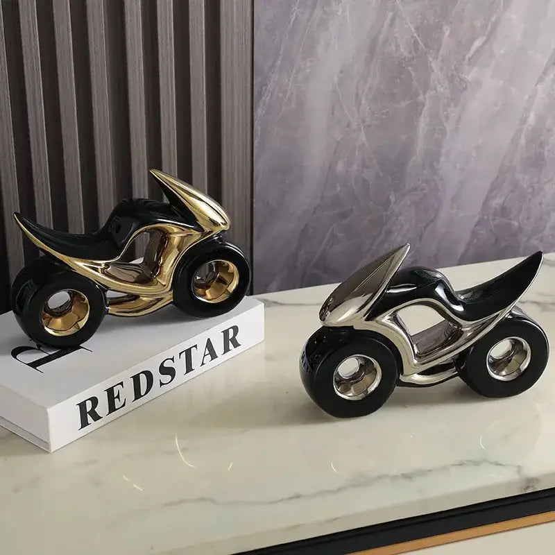 Two sleek ceramic motorcycle light decorations in black gold and black silver on marble for living room display