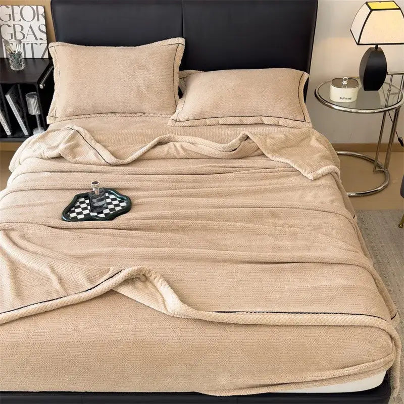 Beige plush decorbites carved velvet blanket with soft texture and black stitched edges for living room use