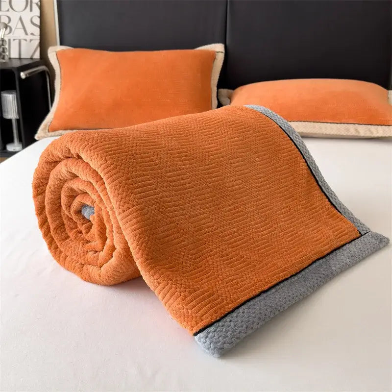 A cozy orange and gray carved velvet blanket with textured fleece and ribbed trim perfect for living room decorbites decor